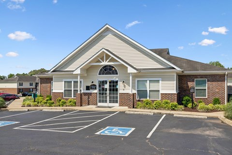 A building with a parking lot in front of it.