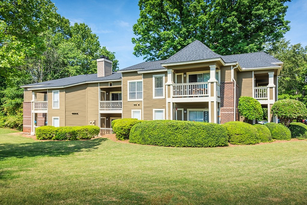 Exterior Of Apartment Homes Overlooking Lush Grass Area