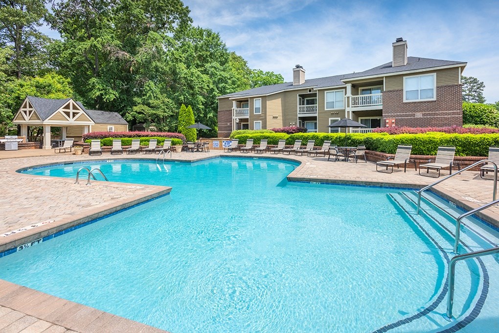 Large Outdoor Pool With Sun Lounge Chairs On The Sundeck