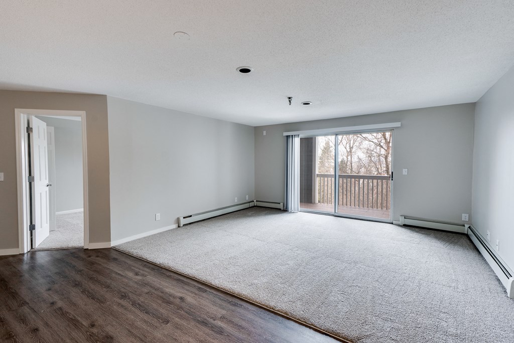 Spacious Living Room with Plush Carpeting with Sliding Patio Door to Balcony