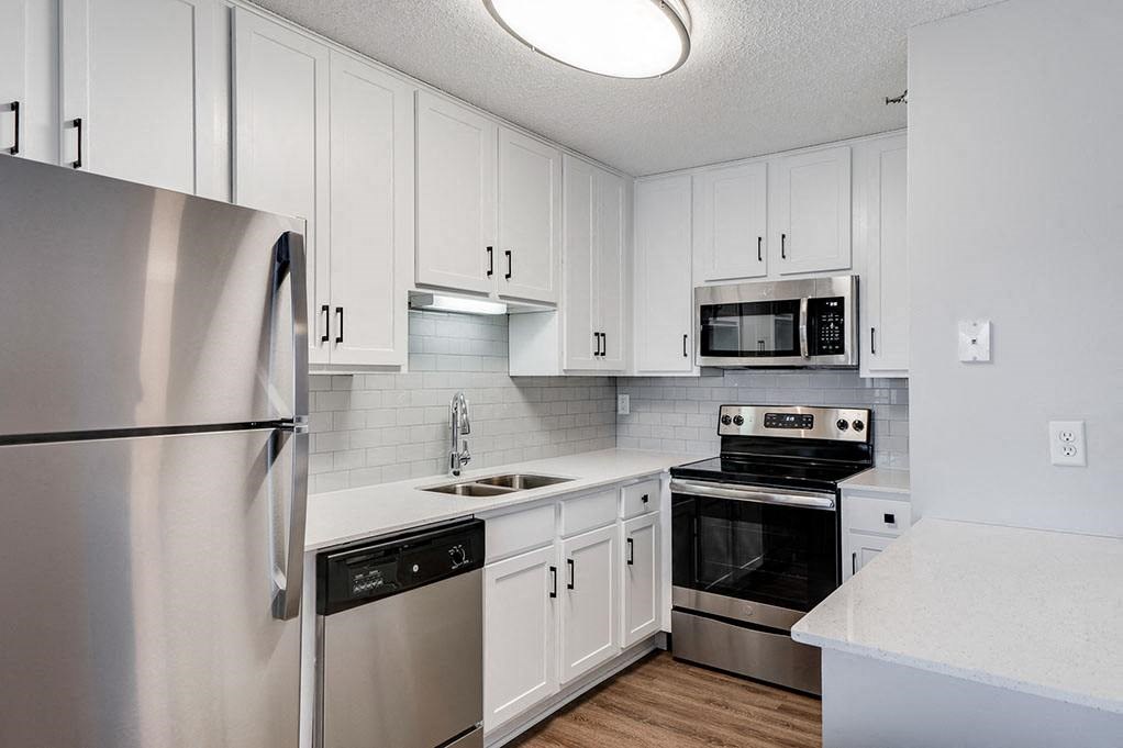 Kitchen with White Cabinetry and Stainless Steel Appliances