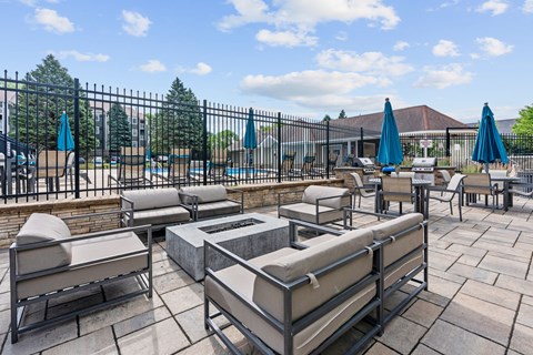 A patio with a pool and sun loungers.