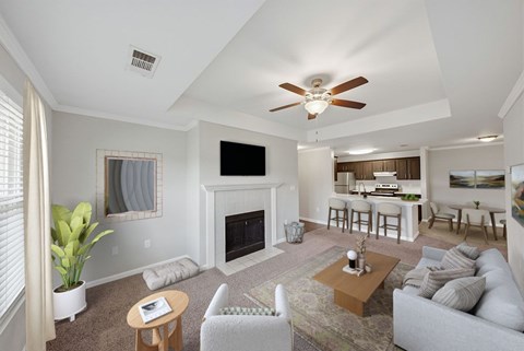 A living room with a fireplace and a ceiling fan.