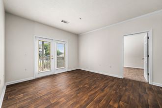 Spacious Living Area With Vinyl Plank Flooring and Patio