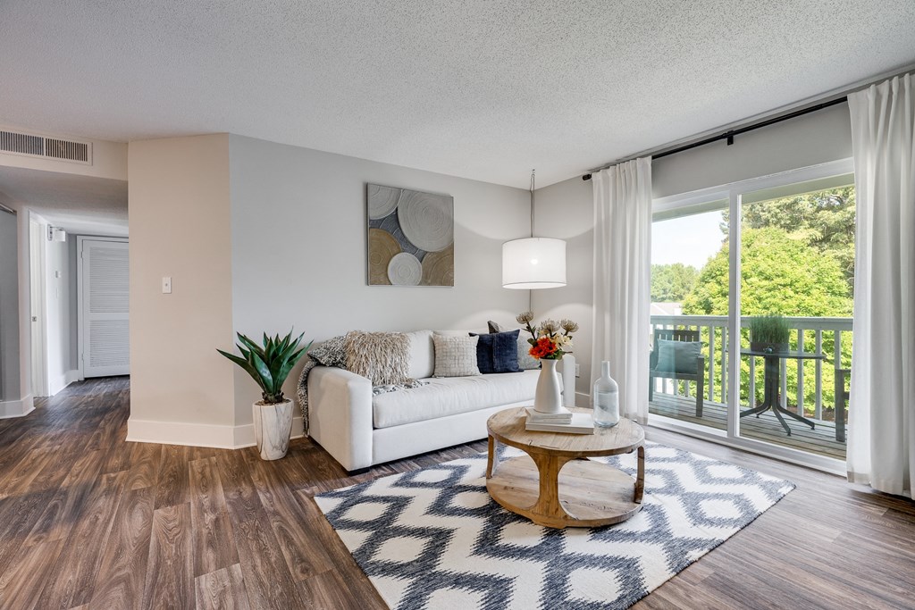 Living Room With Wood-Style Flooring, Light Grey Walls & White Trim