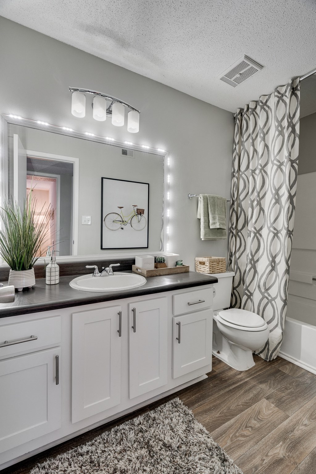 Spacious Bathroom With Wood-Style Flooring