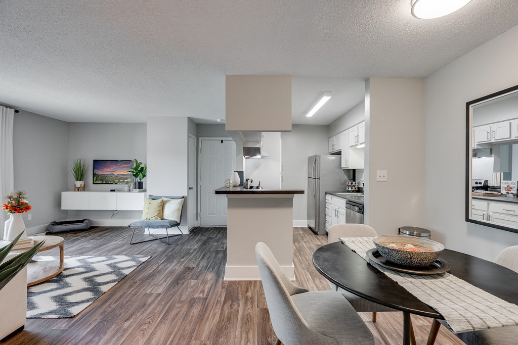 Open-Concept Living With Wood-Style Flooring & White Trim