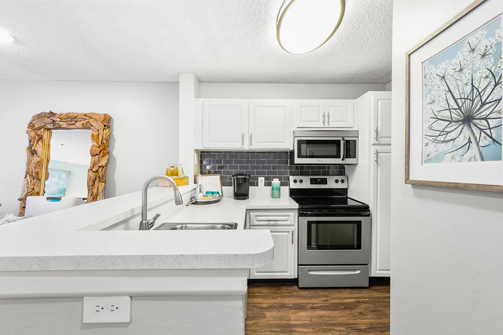Kitchen Featuring White Cabinets & Stainless Steel Appliances