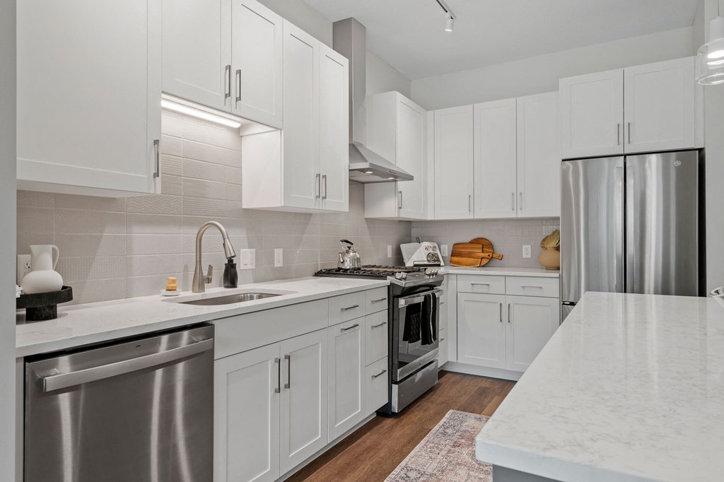 Gourmet Kitchen With Stainless Steel Appliances & White Cabinetry