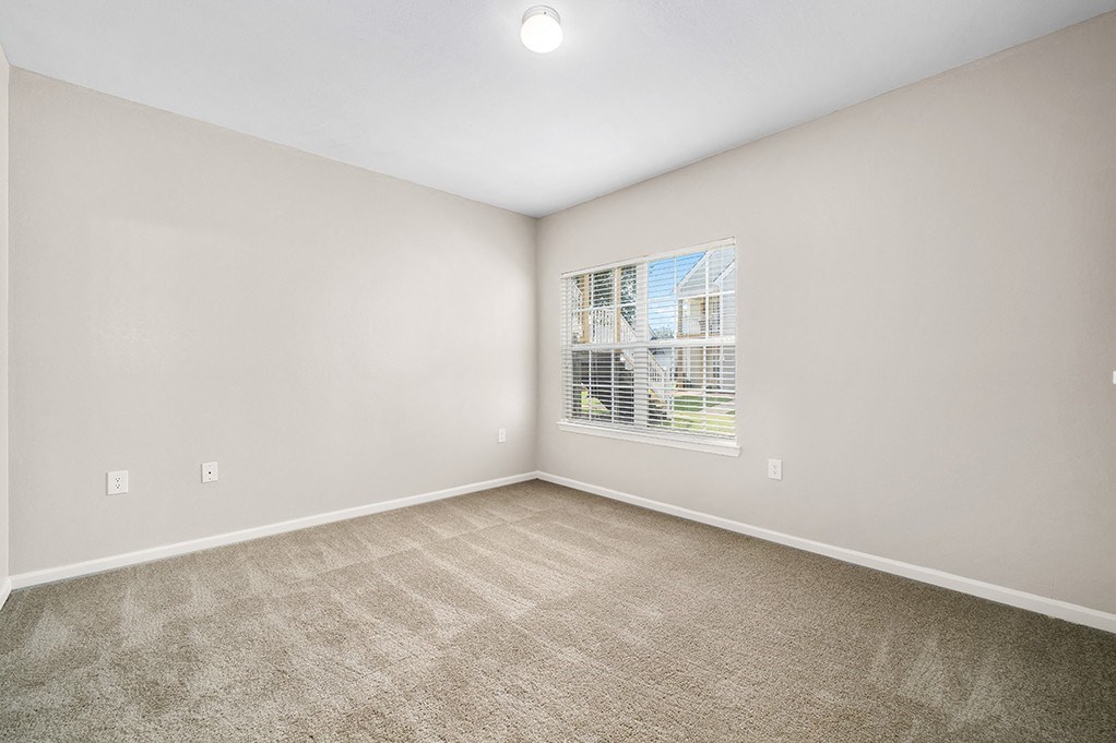 Carpeted Bedroom With Large Windows