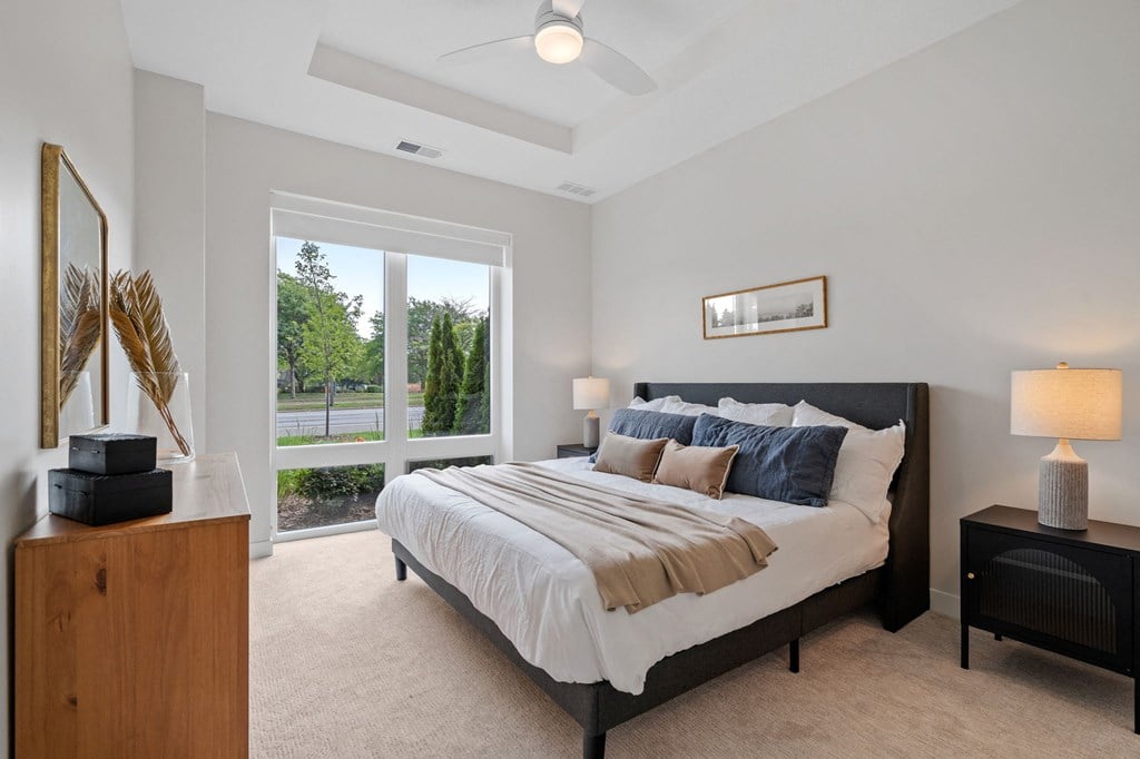 Bedroom Featuring Floor-To-Ceiling Windows With Window Coverings