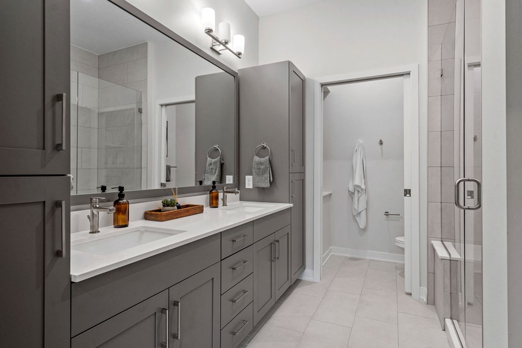 Primary Bathroom Featuring A Double Vanity With Built-In Storage