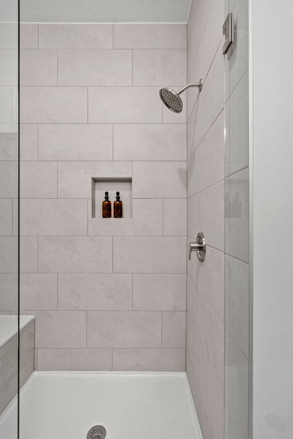 Tiled Shower Featuring Glass Door
