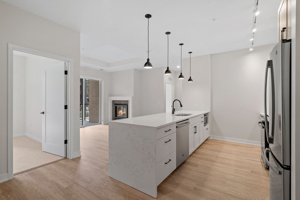 Expansive Kitchen Island with Overhead Lighting