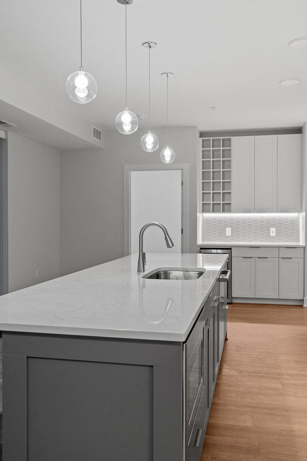 Expansive Kitchen Island with Overhead Lighting