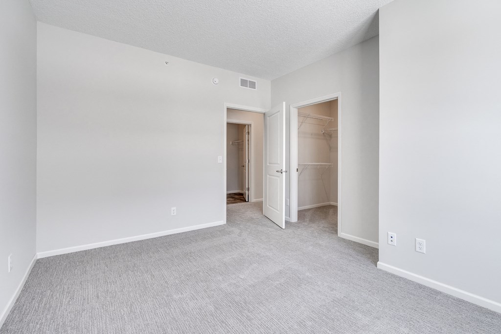 Bedroom Featuring Plush Carpeting & Attached Walk-In Closet