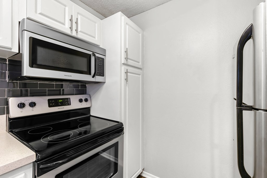 Stainless Steel Appliances & White Cabinets With Pantry