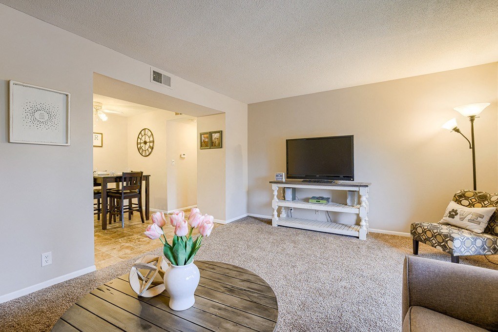 a living room with a tv and a table