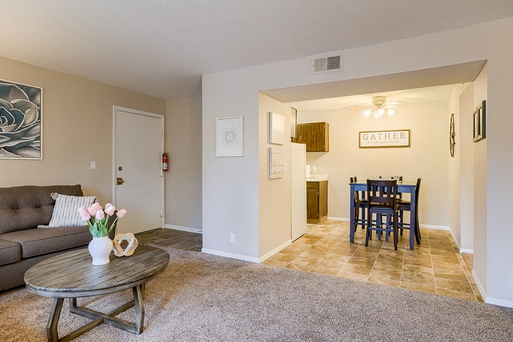 a living room and dining room with a table and a couch