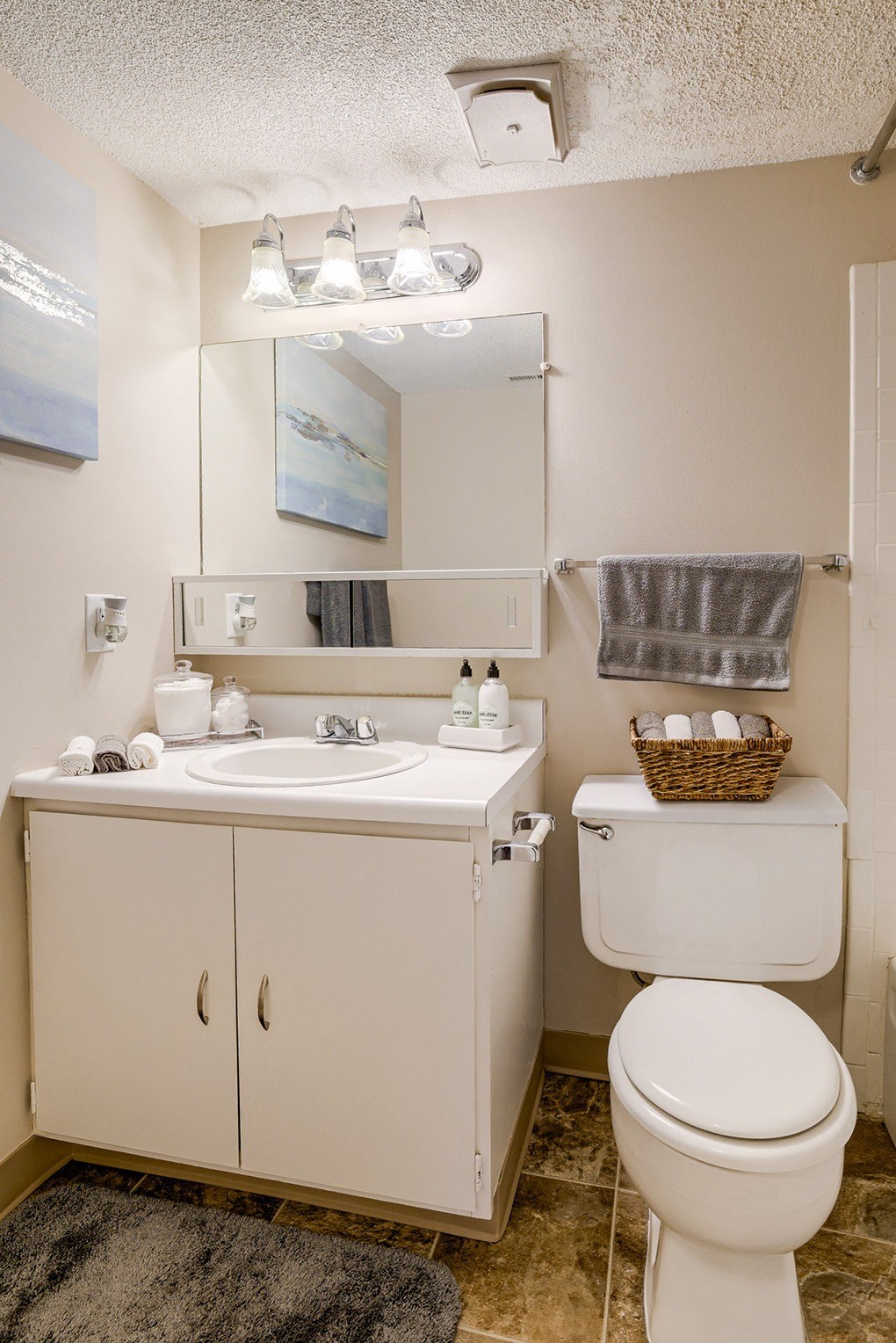 a small bathroom with a toilet sink and mirror