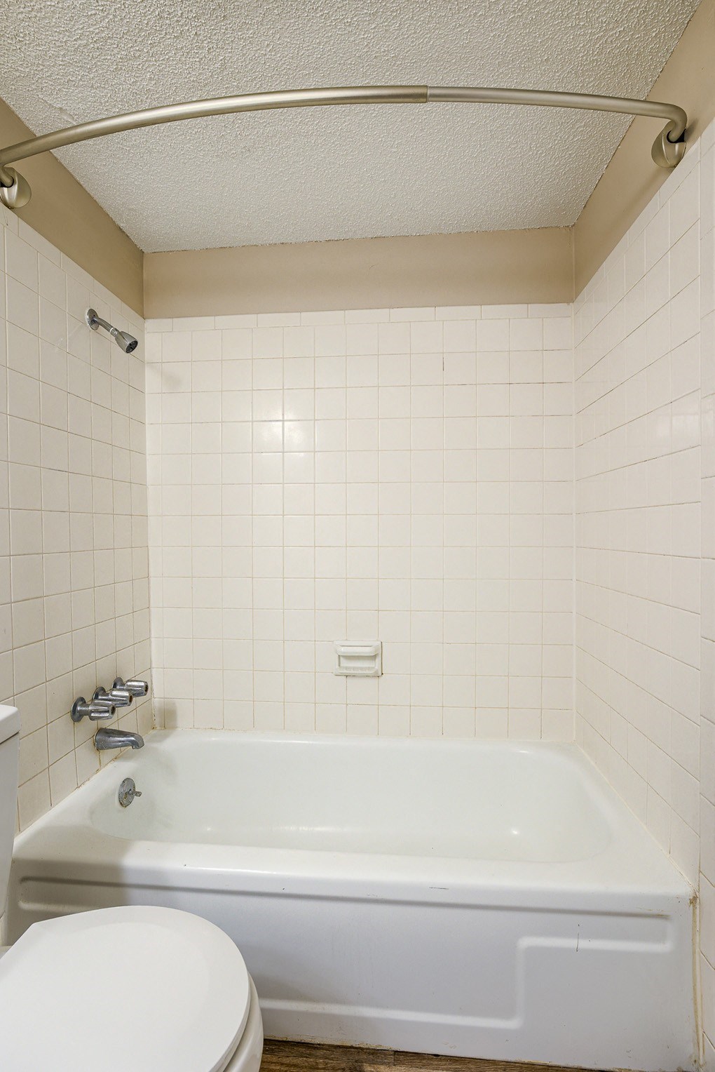 a white bathroom with a tub and a toilet
