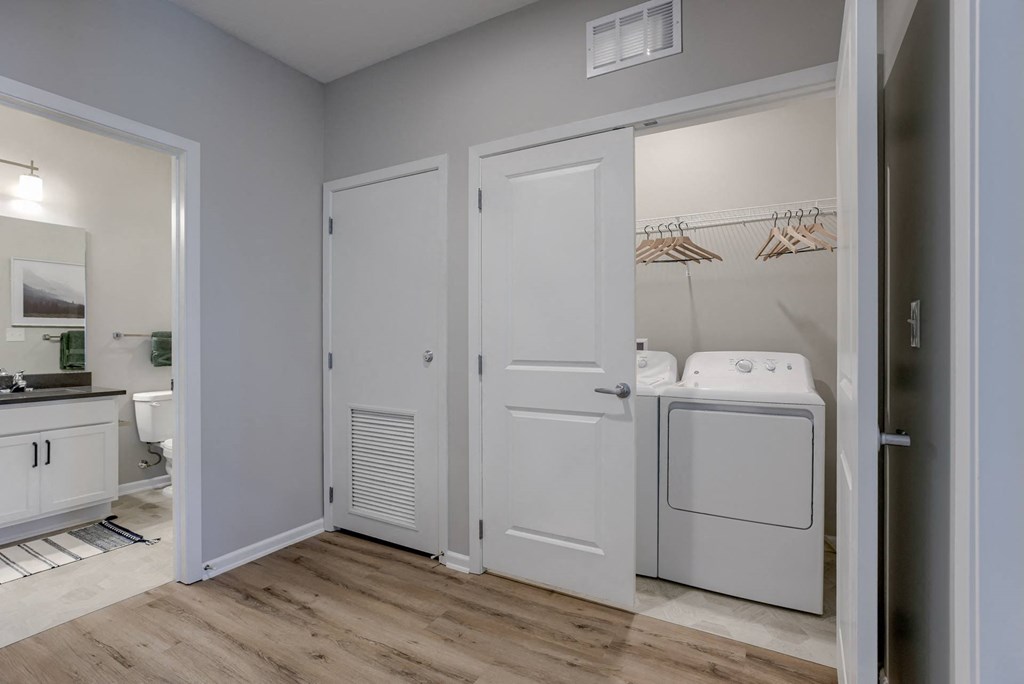 Closet With Washer & Dryer Featuring Built-In Shelves