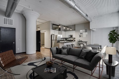 A modern living room with a grey sofa and a coffee table.