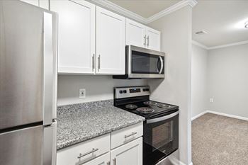 Kitchen with White Cabinetry and Stainless Steel Appliances