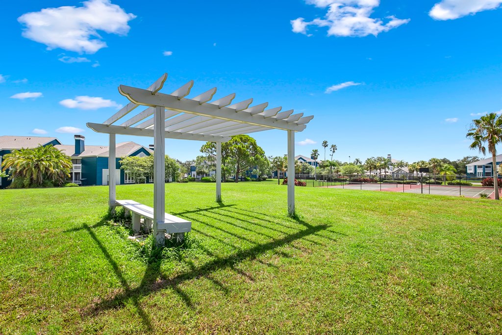 Large Open Green Space With Pergola & Bench