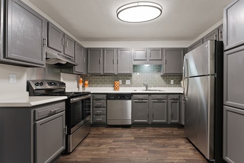 A kitchen with a refrigerator on the right.