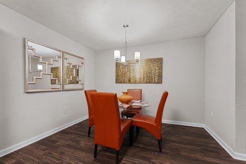A dining room with wood-style flooring