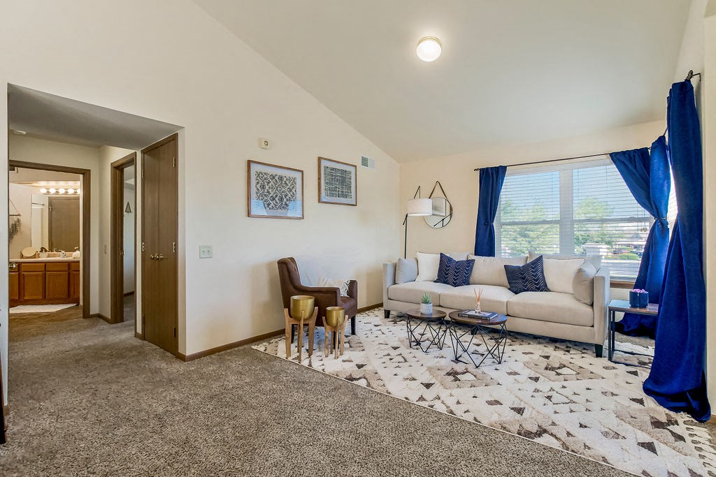 Open Living Room With Lots Of Natural Light & Vaulted Ceilings