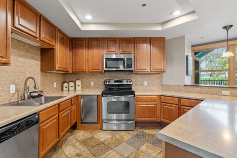 a kitchen with stainless steel appliances and wooden cabinets