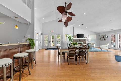 A large open living room with a dining table and chairs.