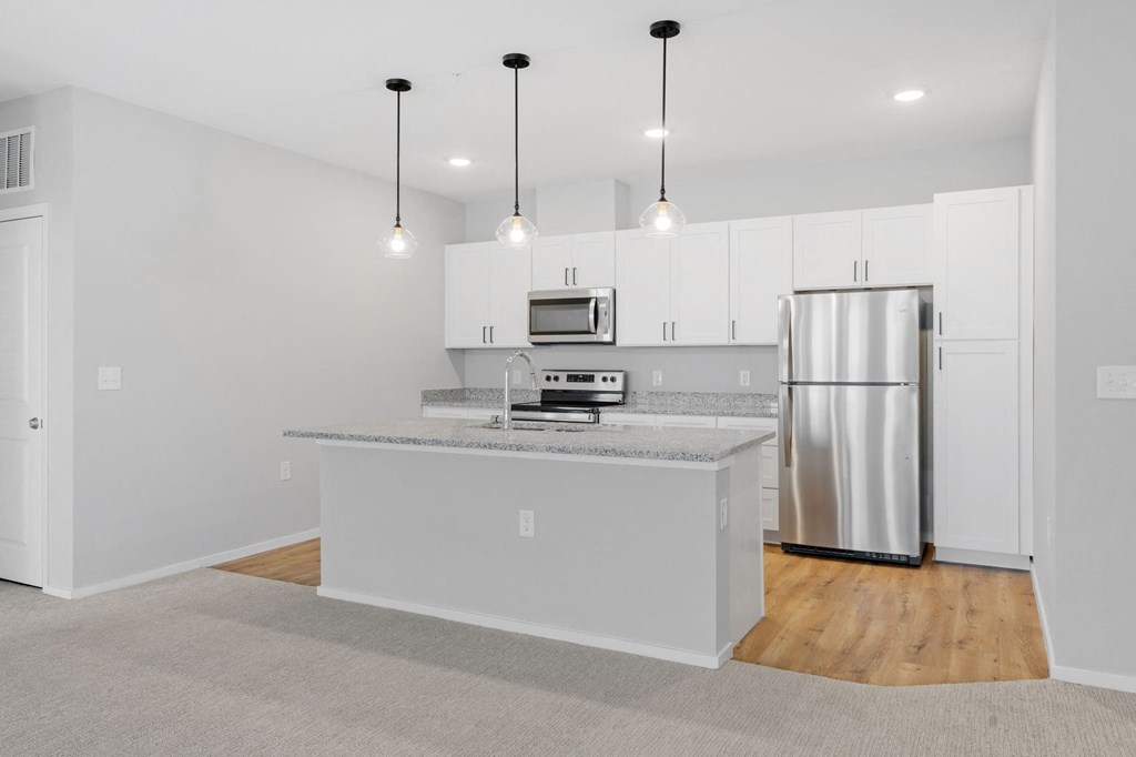 Expansive Kitchen Island with Overhead Lighting