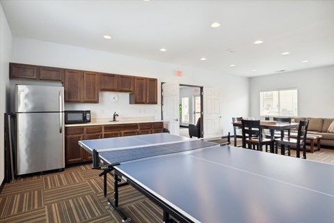 a kitchen and dining room with a ping pong table
