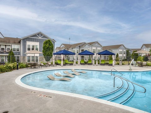 A swimming pool with a slide in the middle of it.