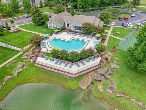 Aerial view of the pool, pond, and community