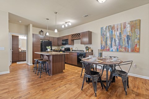 an open kitchen and dining room with a table and chairs