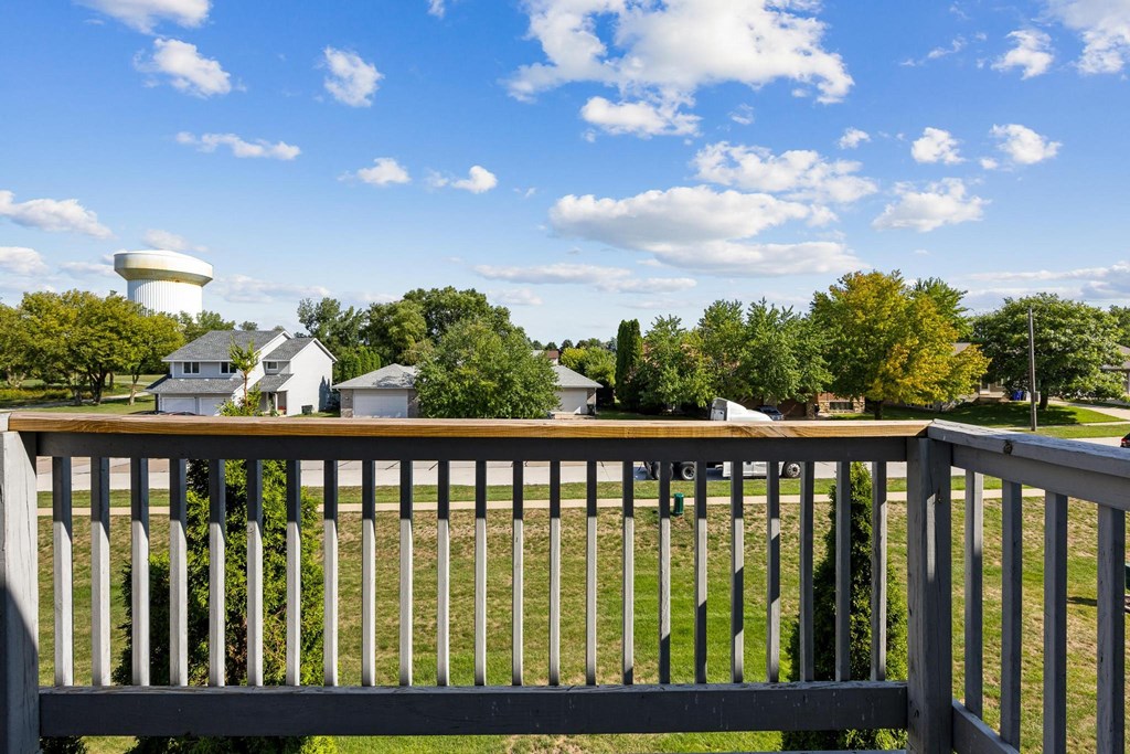 a view from the deck of a home with a water tower in the background
