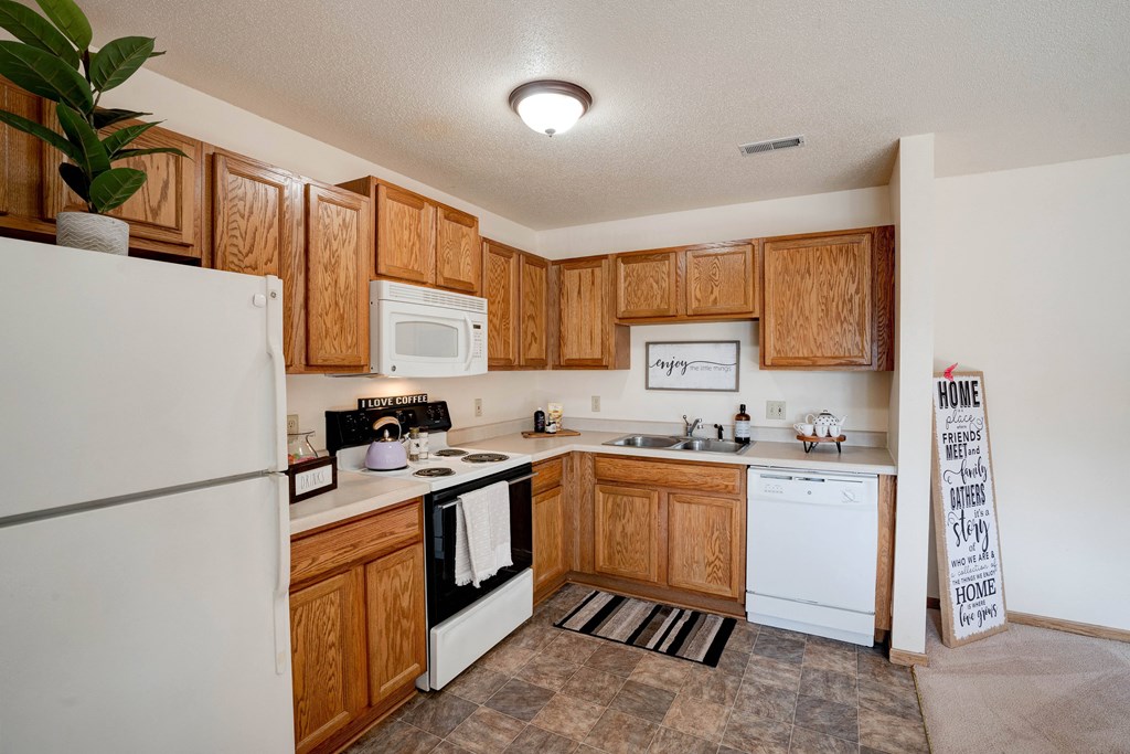 Fully-Equipped Kitchen With White Appliances