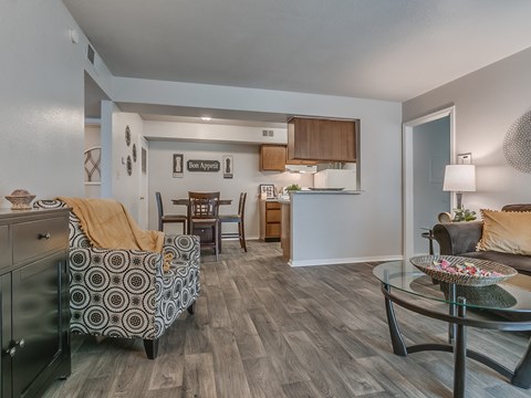 a living room and kitchen with a couch and a table