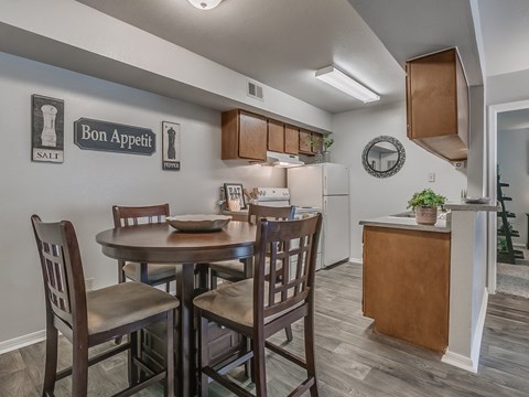 an open kitchen and dining area with a table and chairs