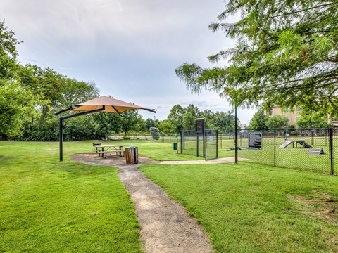 A park with a picnic table and a playground.