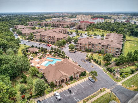 A bird's eye view of a residential complex with a swimming pool.