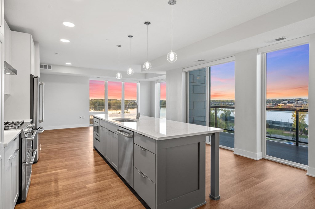 Expansive Kitchen Island with Overhead Lighting