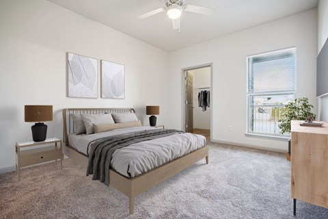 A bedroom with a large bed and a ceiling fan.