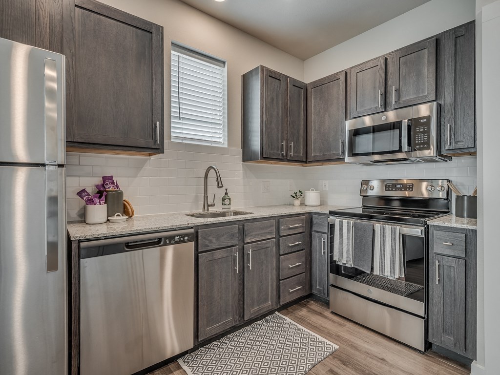 Kitchen with Dark Brown Cabinetry and Stainless Steel Appliances