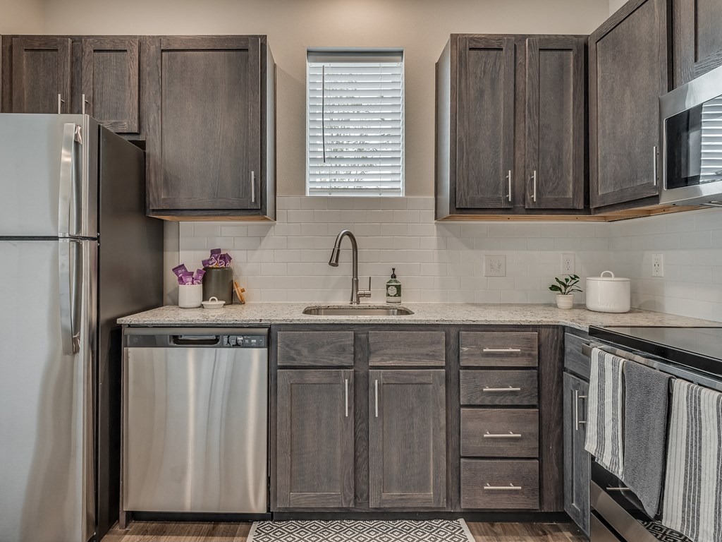 Kitchen with Dark Brown Cabinetry and Stainless Steel Appliances
