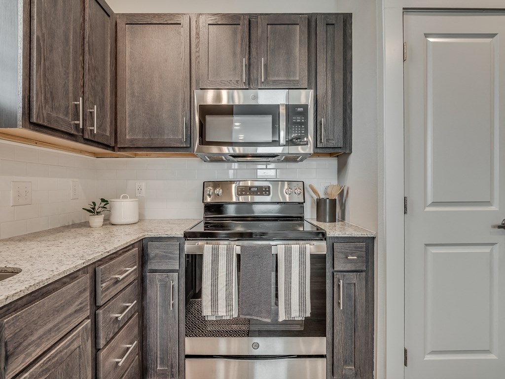 Kitchen with Dark Brown Cabinetry and Stainless Steel Appliances